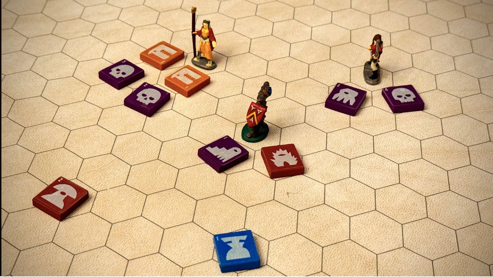 A single QuoDrox tile placed next to several different miniature types it can represent
