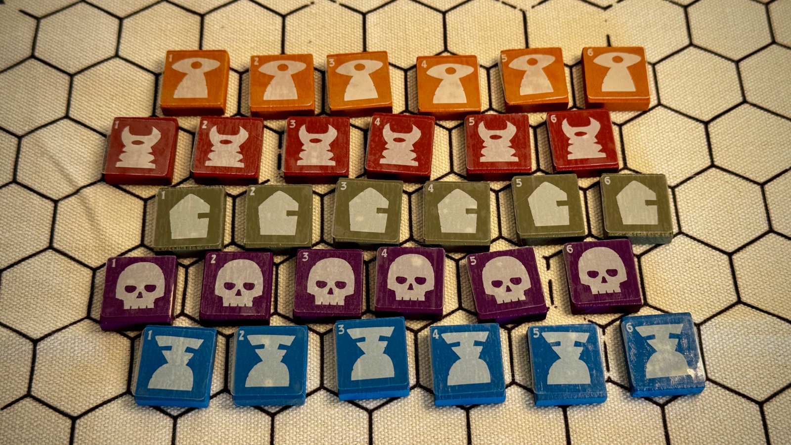 QuoDrox tiles from multiple packs fanned out showing color coding and corner numbers